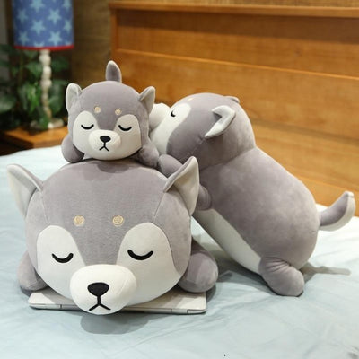 3 shiba inu plush miniso laying on top of each other
