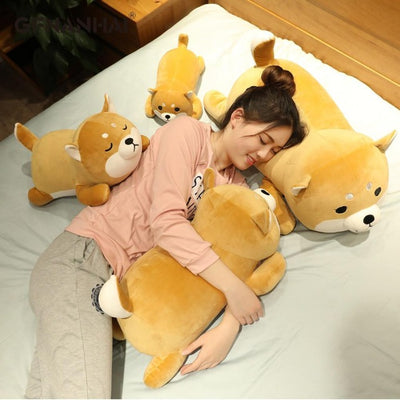 Woman laying on a kawaii shiba inu plush, with 4 others
