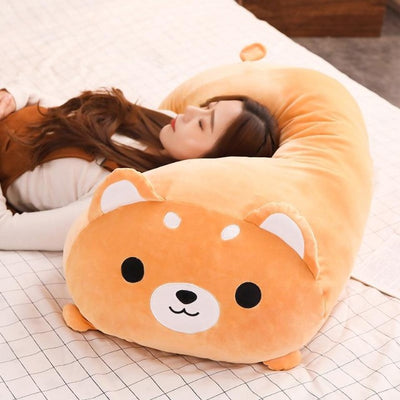 Woman laying on a plush shiba toy orange