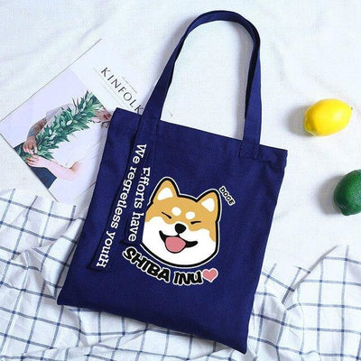 Shiba that is smiling on a blue bag