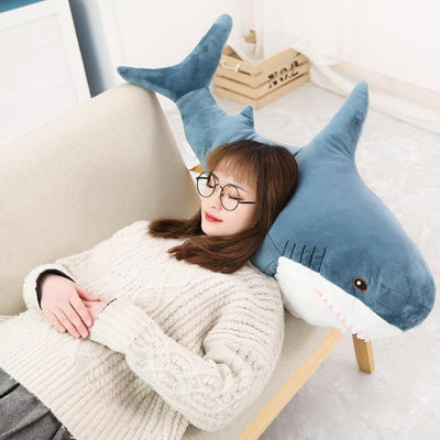 japanese girl using a shark plush as a pillow