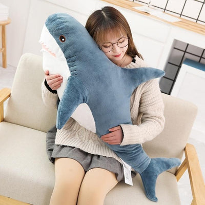 woman hugging a shark stuffed toy