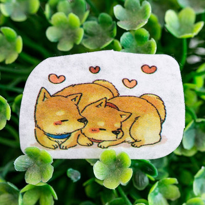 Shibas sleeping next to each other with hearts in stickers