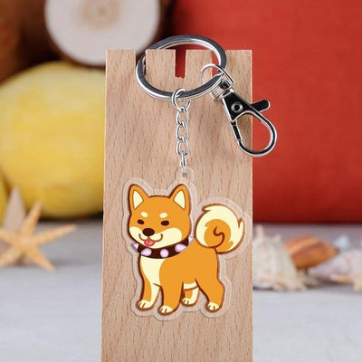 Shiba dog on a keyring hanging from a wooden key holder