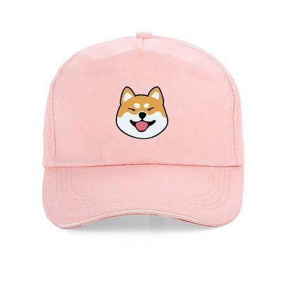Shiba with tongue out on a pink cap