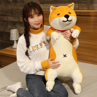 Woman holding a yellow shiba plush animal