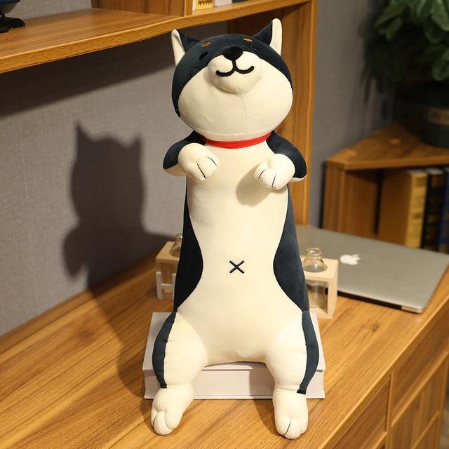 Black plush in the shape of a smiling shiba