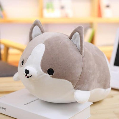 A gray grinning corgi plush pillow with black eyes