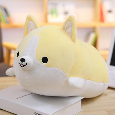 A yellow dog stuffed animal with pointy ears