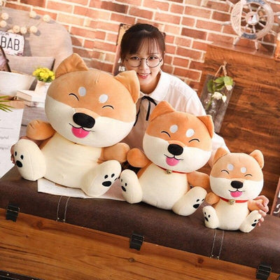 Woman sitting with 3 shiba plushies in a row like a cartoon