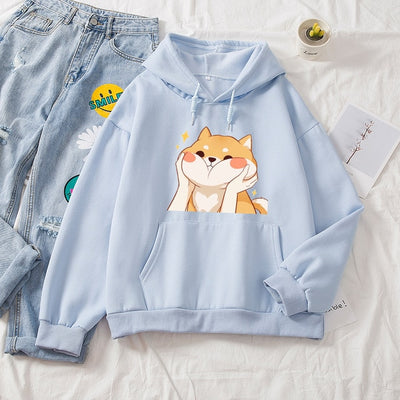 A shiba inu on a blue hoodie