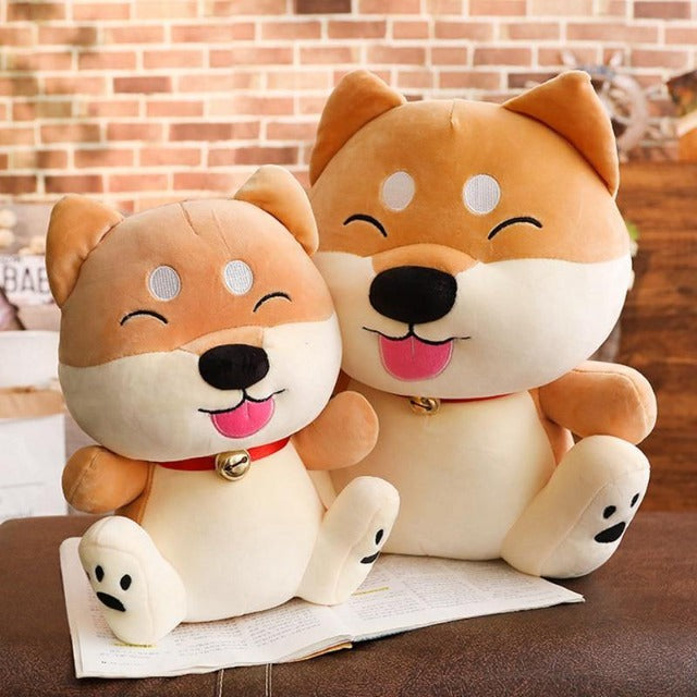 two cartoon shiba plushies sitting on a desk