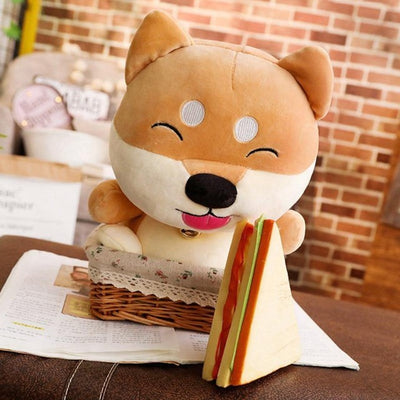 Cartoon faced shiba plush stuffed animal looking at a sandwich