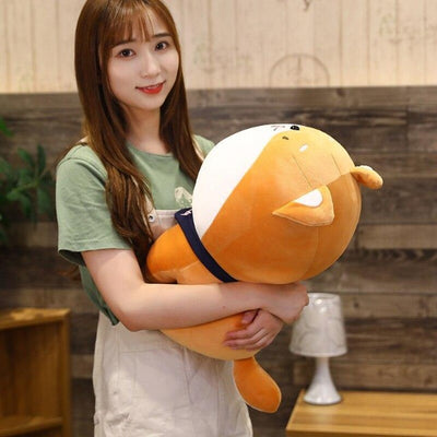 Woman hugging a shiba dog plush with big head