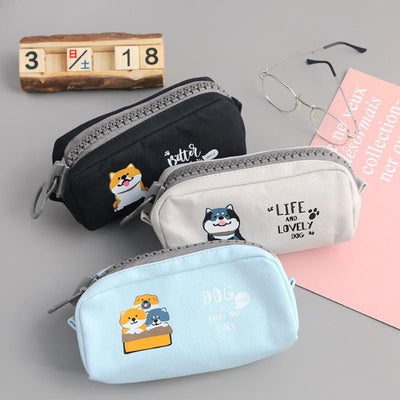 Black gray and light blue pencil case with shibas on them