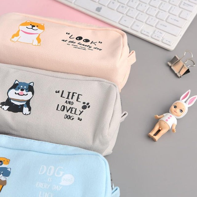 Three bags that have a shiba design and contain pens