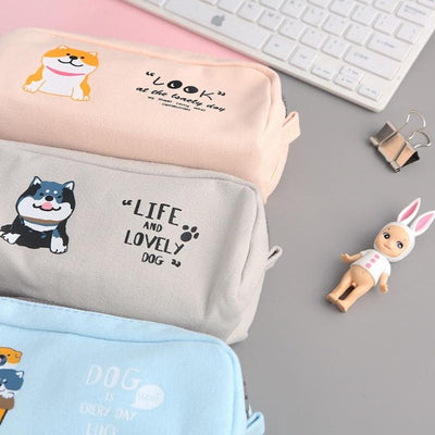 Three bags that have a shiba design and contain pens
